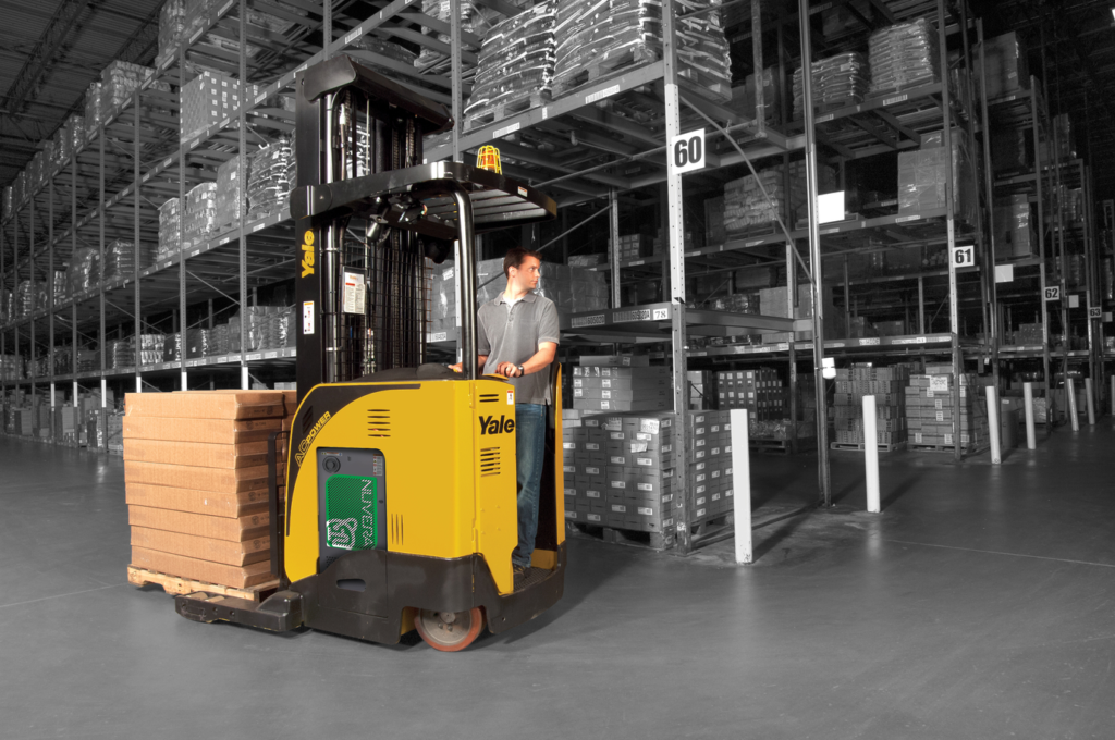 man driving loaded Yale forklift through warehouse