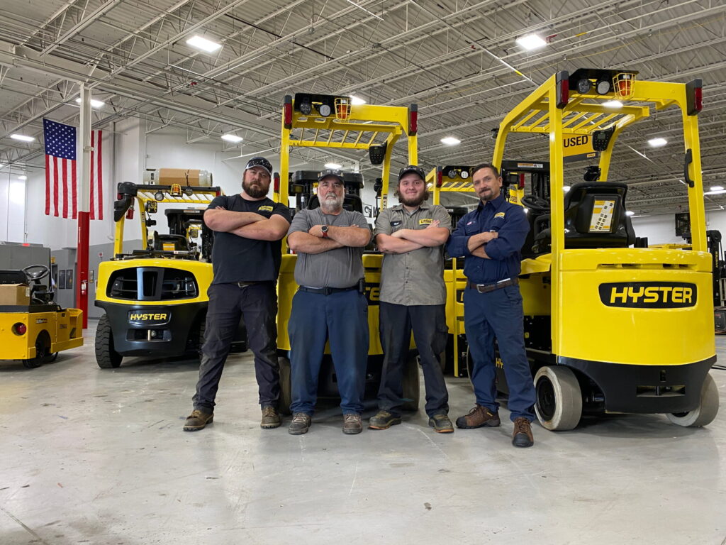 LiftOne support team standing in front of forklifts