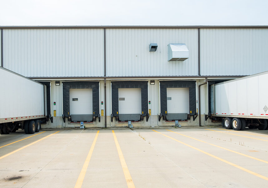 Warehouse building with 53 foot dry van trailers backed into docking doors